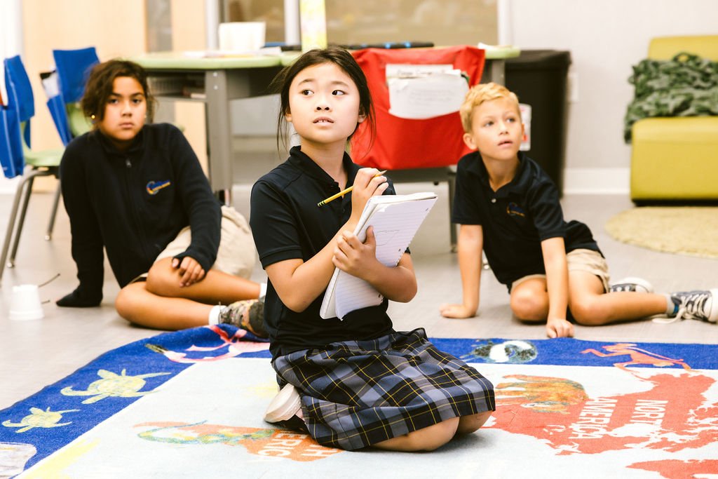 Students engaged in independent reading and learning in modern library space